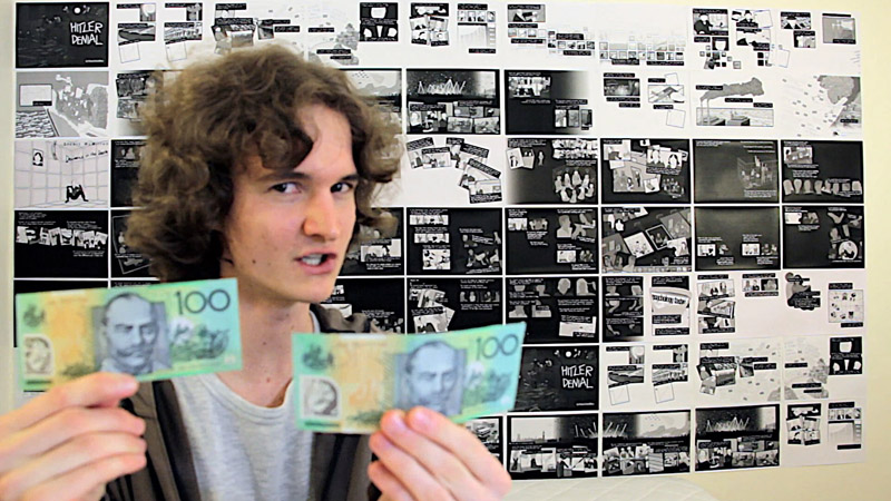 Stuart McMillen crowdfunding video holding two $100 notes