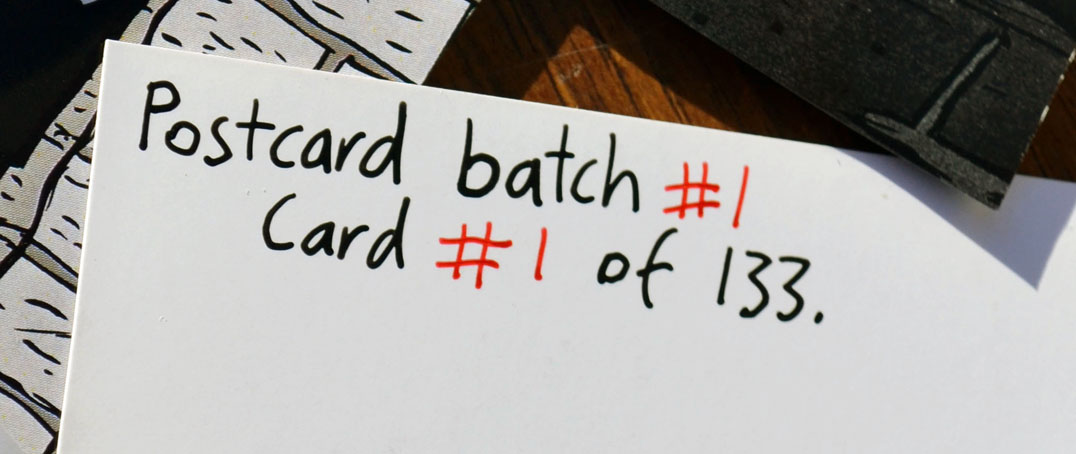 Handwritten text in black and red writing: "Postcard batch #1. Card #1 or 133."