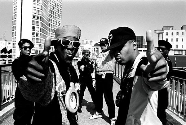 Public Enemy black and white photo. Flavor Flav and Chuck D on a bridge posing.