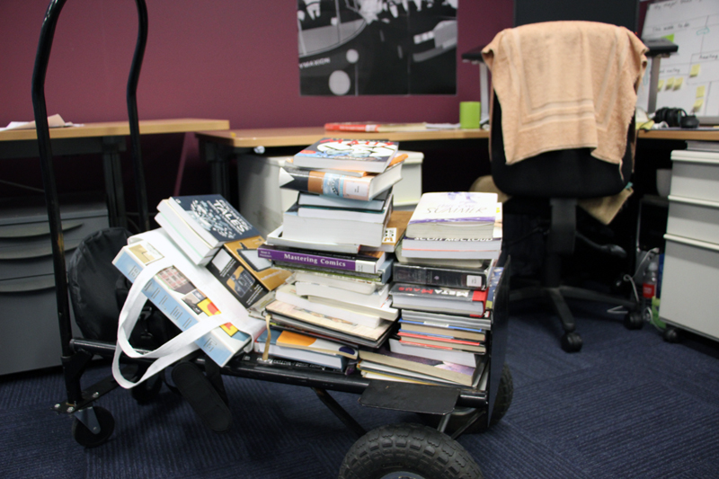 Trolley of graphic novel books for book review video.