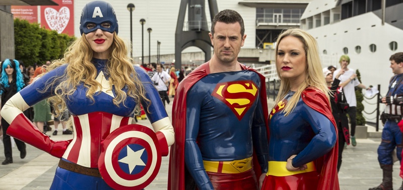 DC Comics cosplay trio: female Captain America, Superman, Supergirl