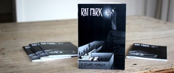 Rat Park printed comics arranged on a table