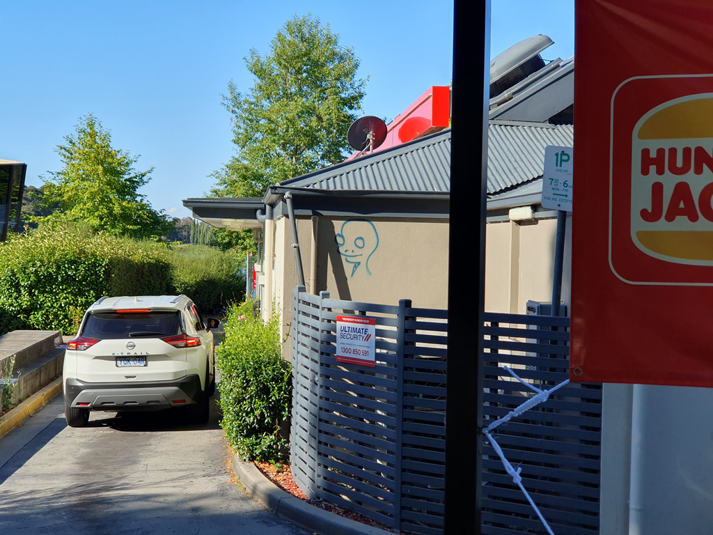 Belconnen Hungry Jack's restaurant with alien graffiti tag