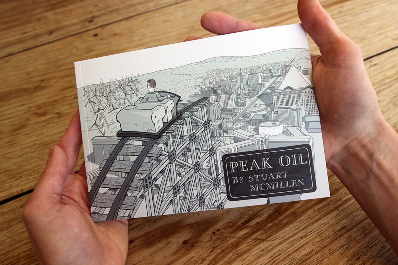 Peak Oil comic book front cover being held in a pair of hands